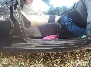 My wife jerks off my cock in the car in the parking lot