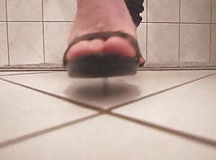 Walking on black sandal heels in bathroom with footjob