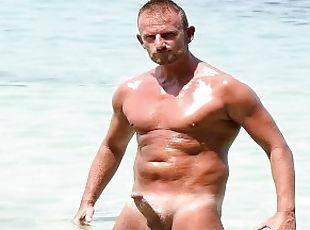 muscle hunk playing with his big dick on public beach