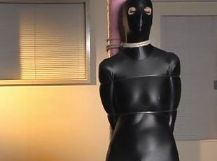 Spandex zentai babe with fishing line tied to concrete post