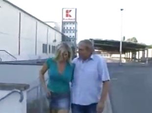 German  woman fucks with a new friend in front of the car park